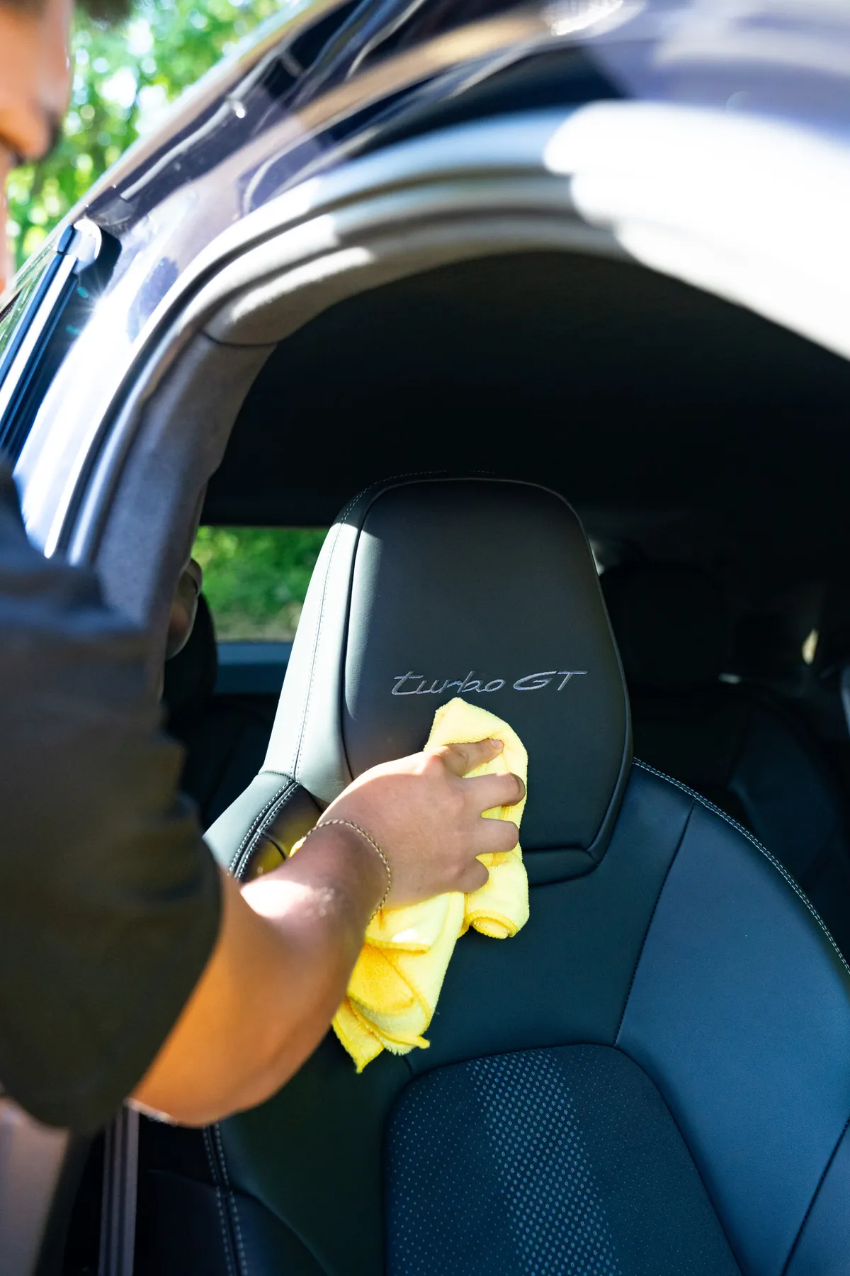 A technician working a mark out of the back of a Porsche Turbo GT seat