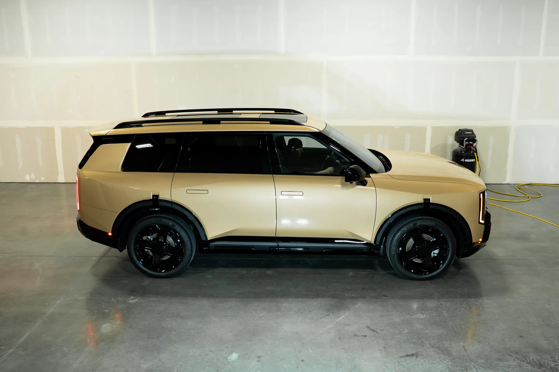 A finished Kia EV9 standing in the studio bay after coating
