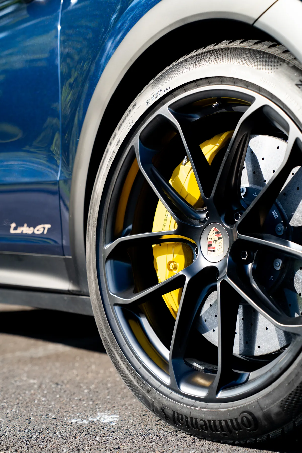 A cleaned Porsche Cayenne Turbo GT wheel with yellow brake calipers behind the spokes